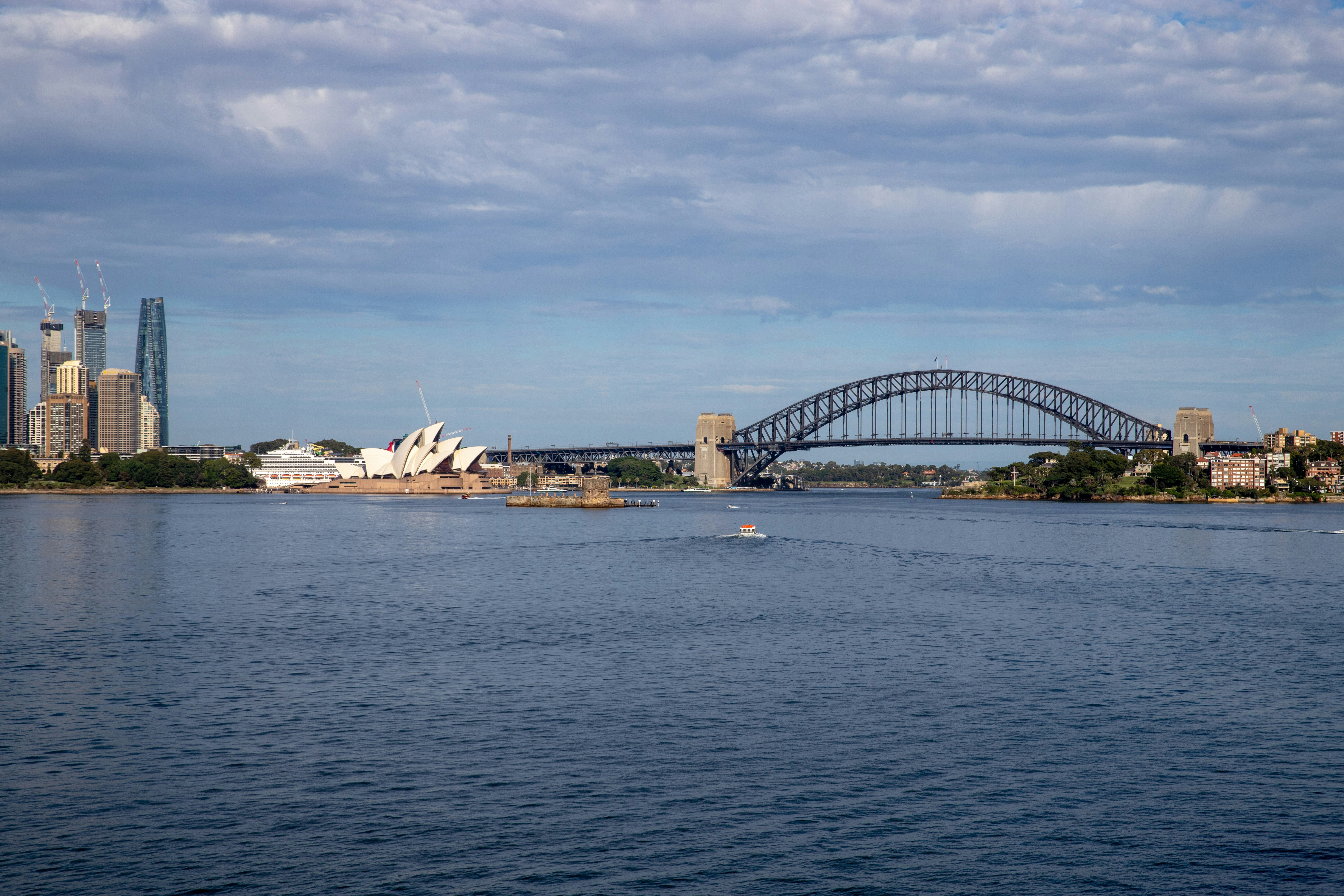 a large body of water with a bridge in the background