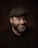 a man with a beard wearing a hat