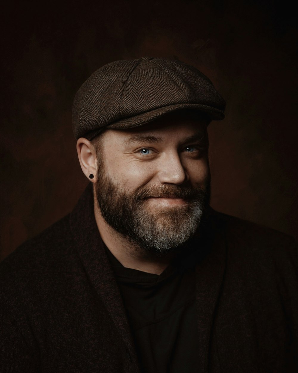 a man with a beard wearing a hat