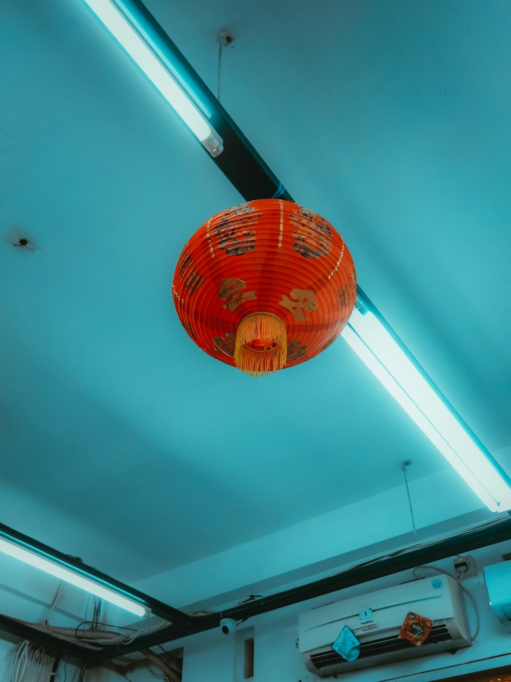 a red light hanging from the ceiling of a room