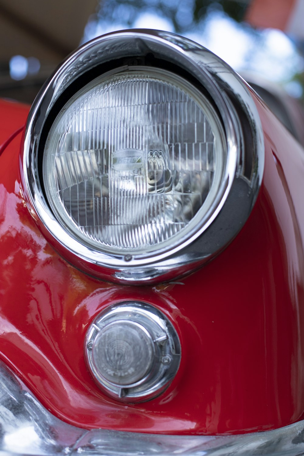 a close up of a red motorcycle headlight
