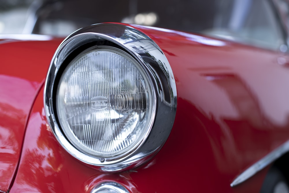 a close up of a red car headlight