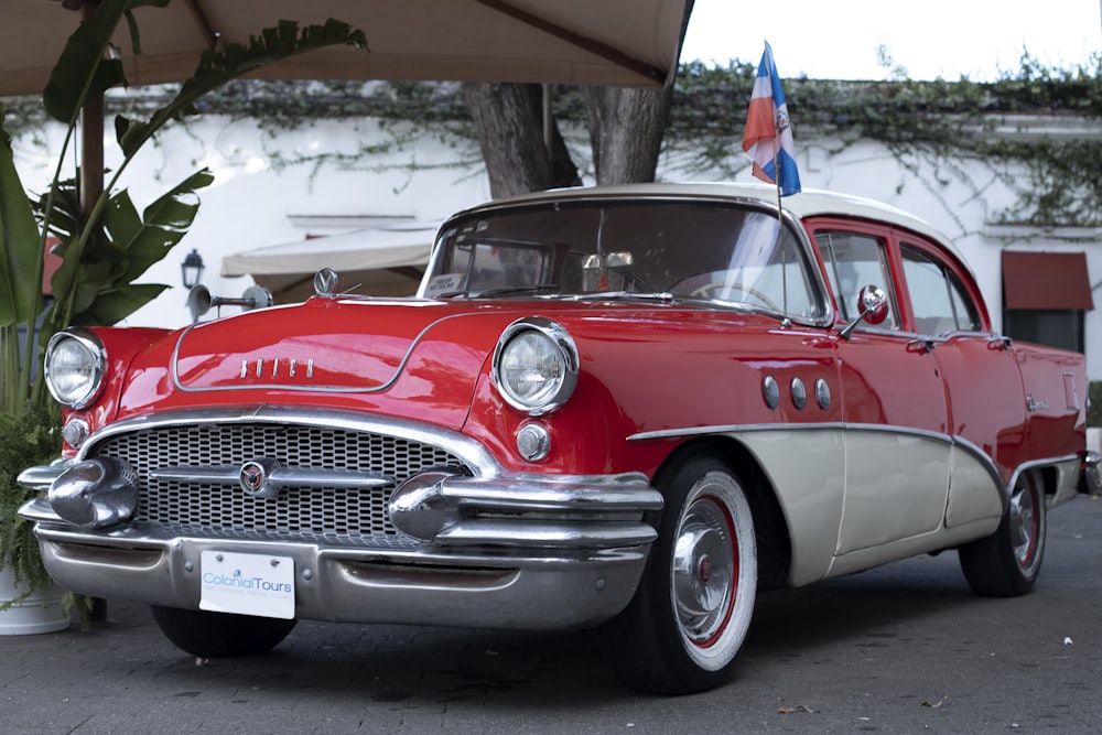 a red and white car parked under a canopy