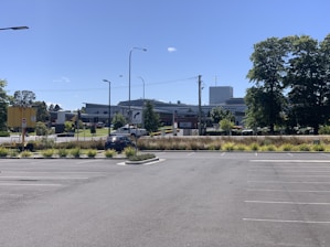 A spacious parking lot with clearly marked spaces for cars.