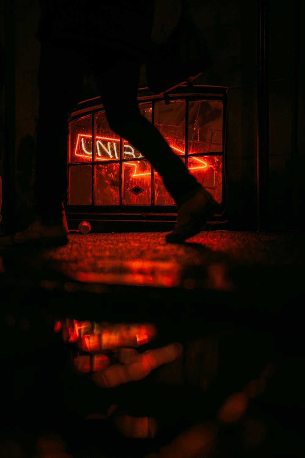 a person walking down a street at night