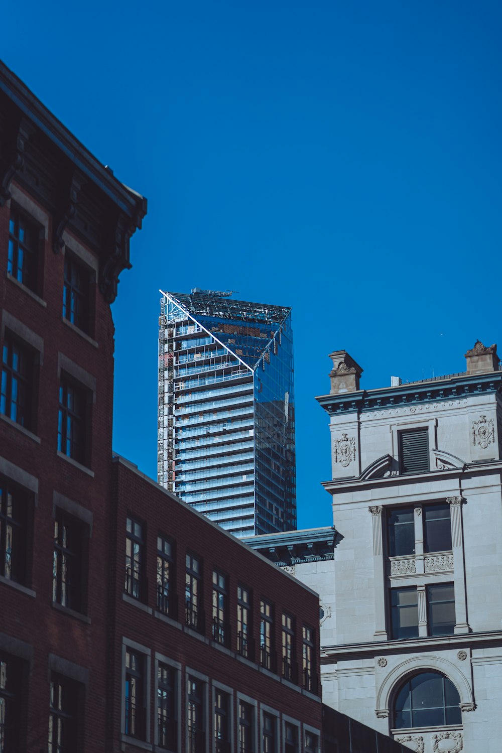 a tall building next to a very tall building