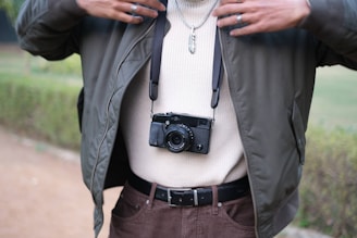 Lifestyle shot of a woman wearing a green olive-toned pendant, smiling softly in an outdoor setting.