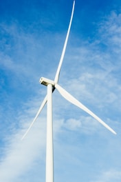 a wind turbine is shown against a blue sky