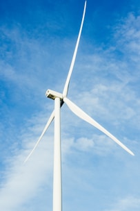 a wind turbine is shown against a blue sky