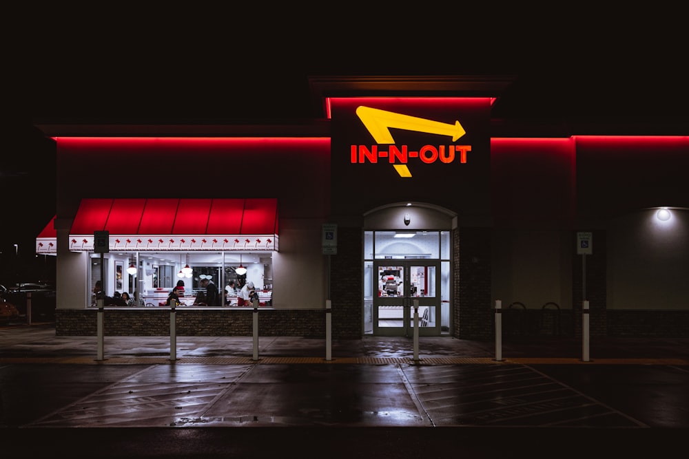 an in - n - out store lit up at night
