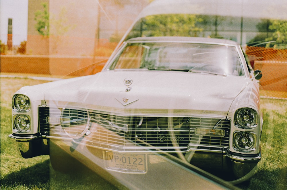 a white car parked in front of a building