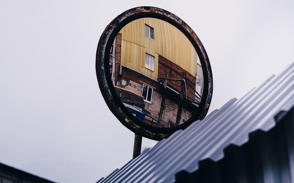 a reflection of a building in a round mirror