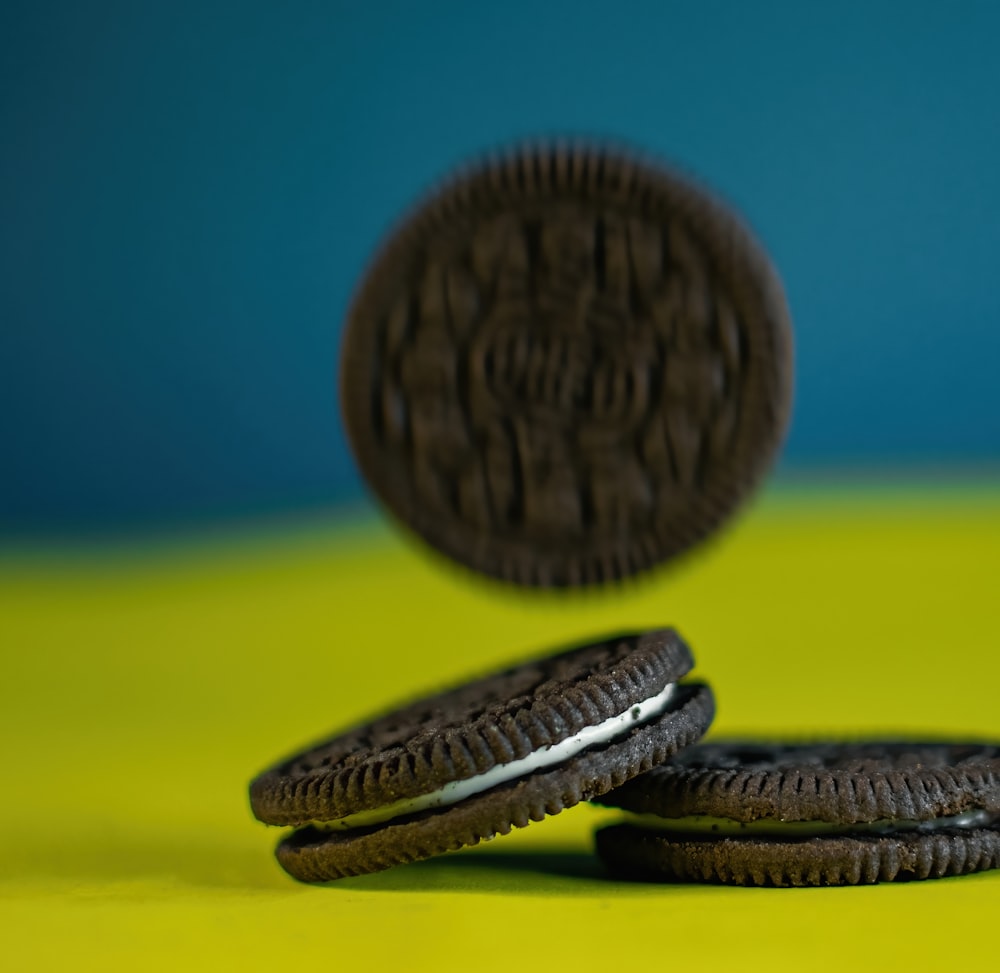 two oreo cookies sitting on top of a yellow table