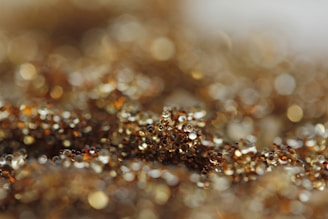 Detailed shot of shimmering gold beads catching the light on a handcrafted purse