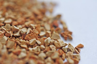 A close-up of yeast granules on a wooden surface.