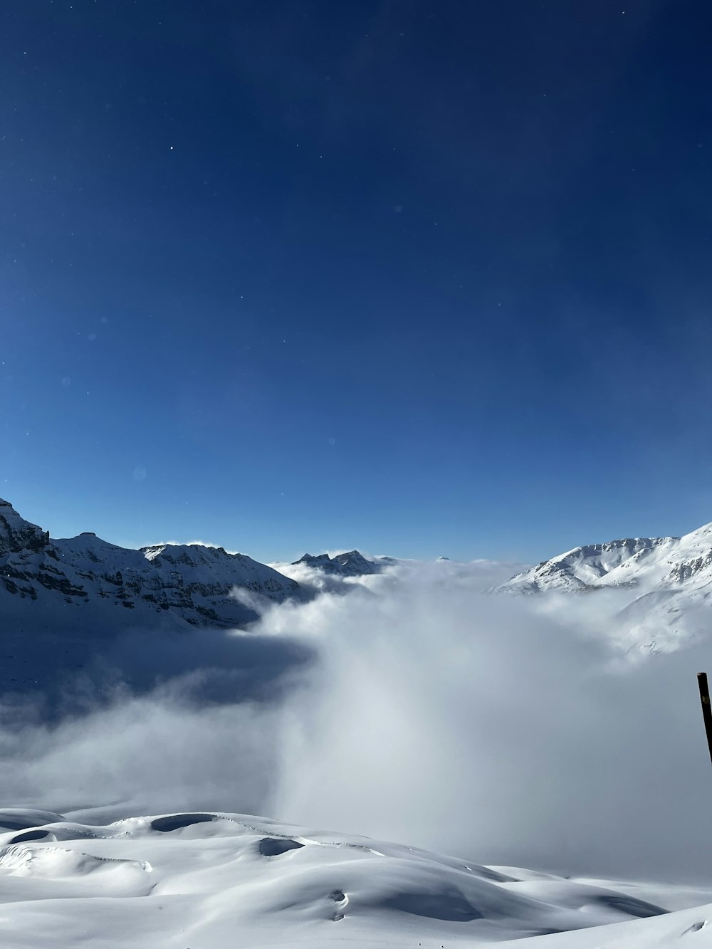 a person standing on top of a snow covered slope