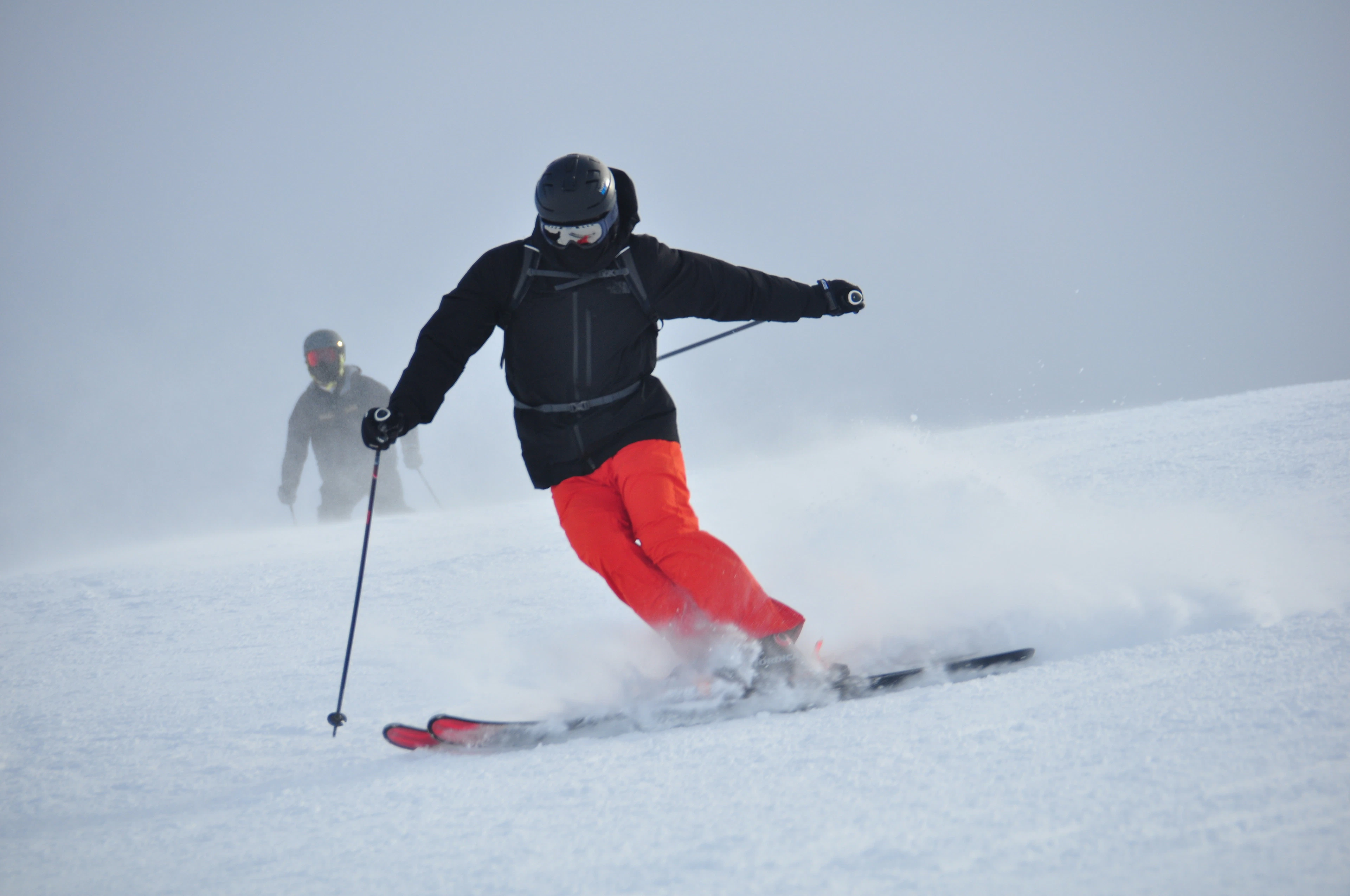 A skier throwing up powder on a run in Formigal