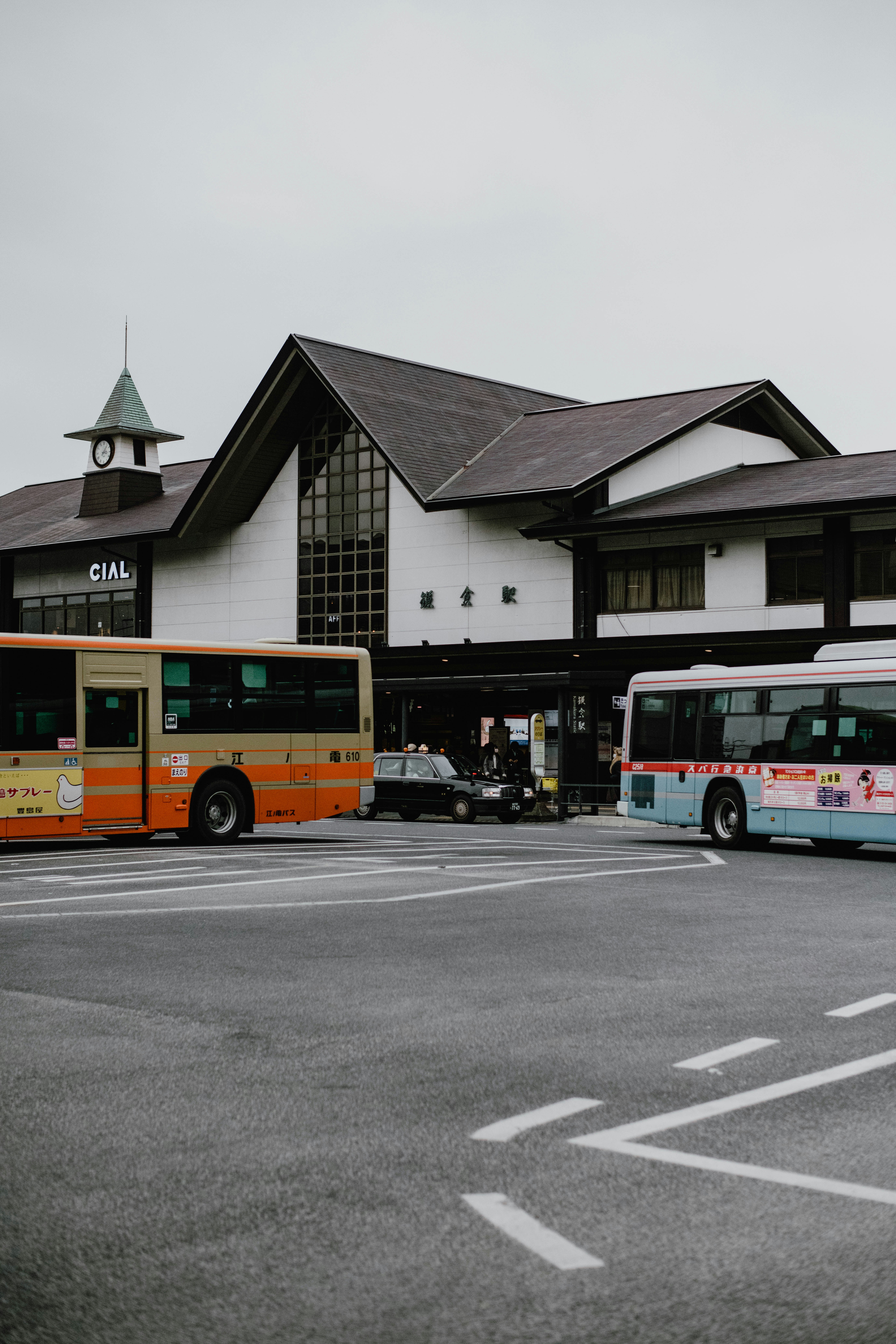 a couple of buses that are parked in front of a building