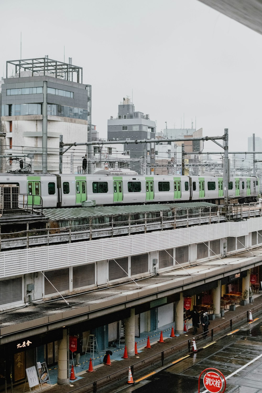 a green and white train traveling down train tracks