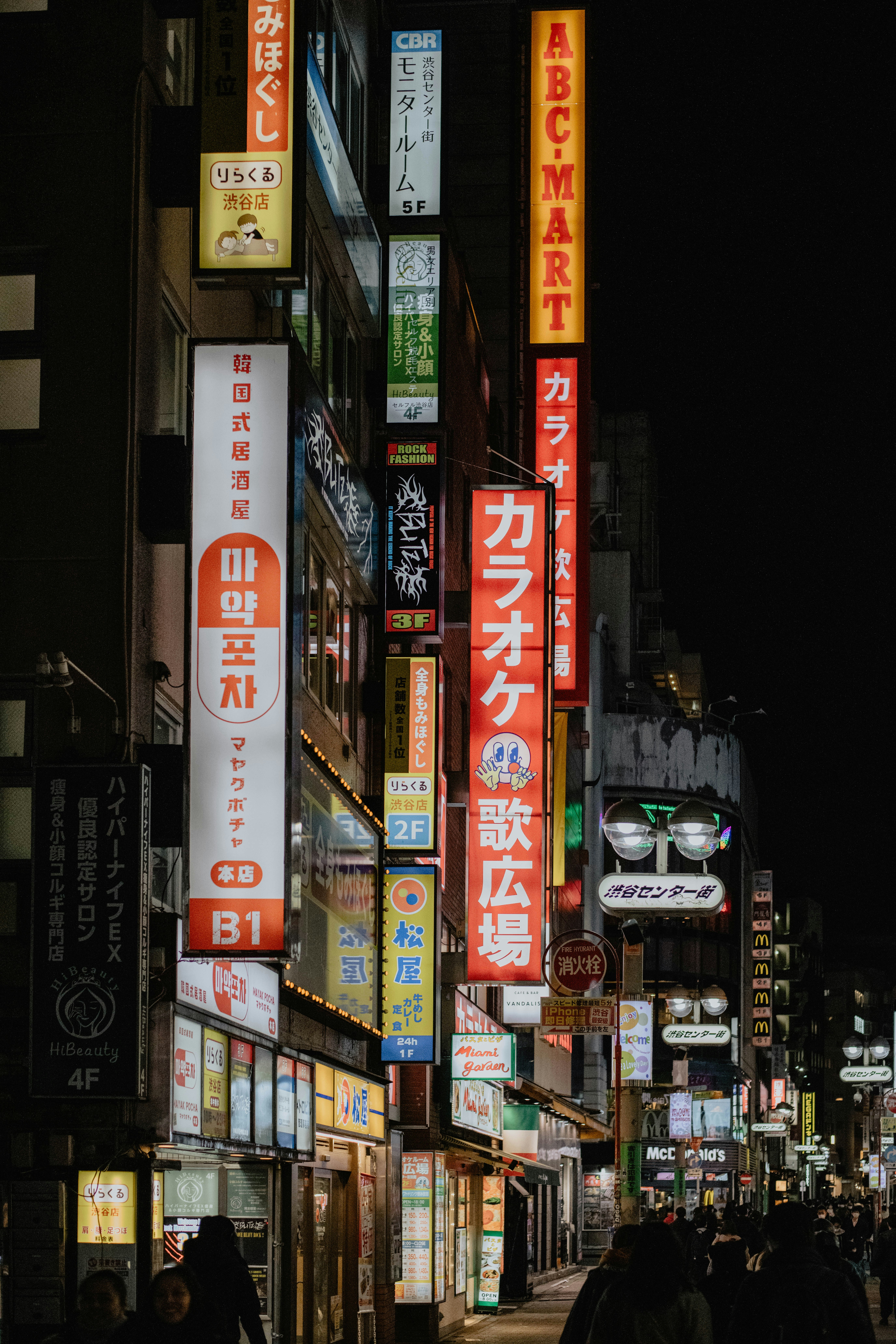 a city street filled with lots of neon signs