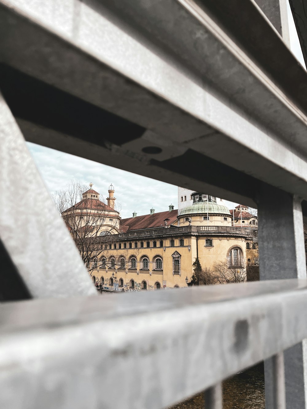 a view of a building through a metal fence