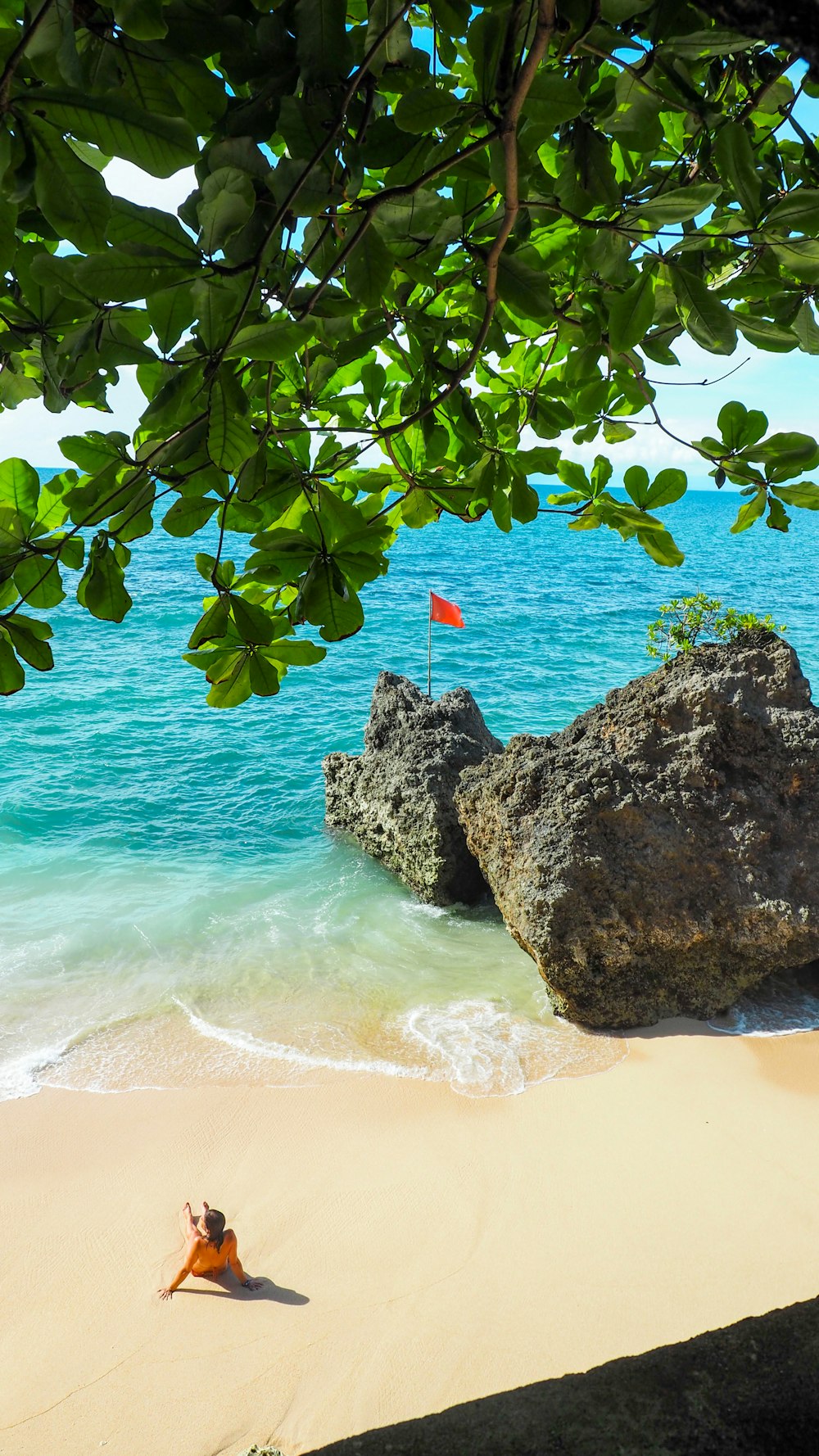 a person laying on a beach next to the ocean