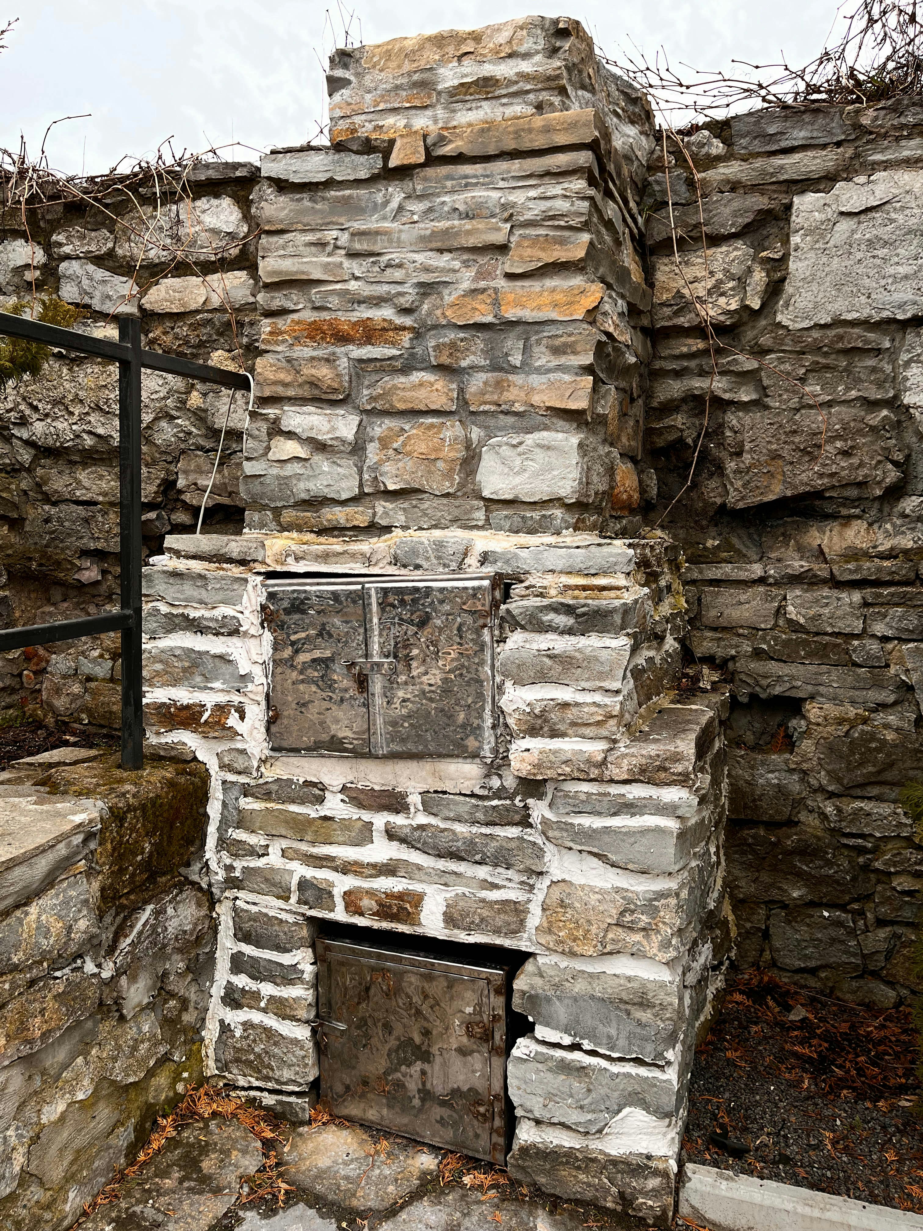 a stone fireplace with a window in the middle of it