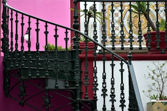 a stair case next to a pink wall
