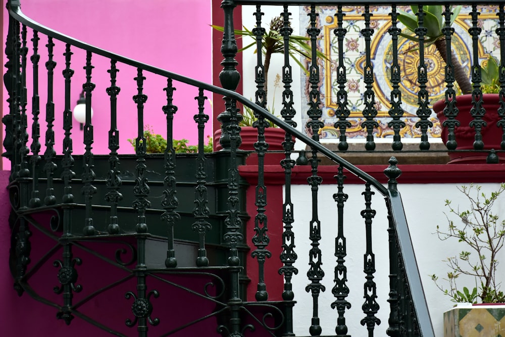 a stair case next to a pink wall