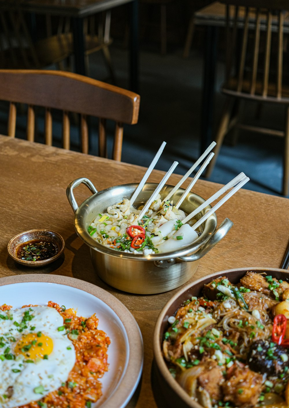 a wooden table topped with plates of food