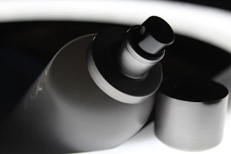 Close-up of a professional spray gun with red and black accents on a workshop table.