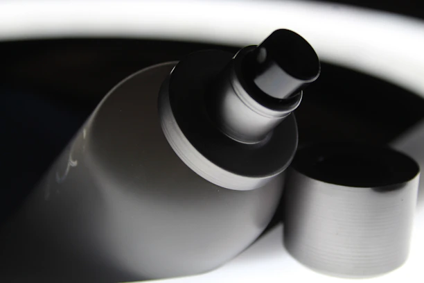 Close-up of a bed bug treatment spray bottle with a clean bedroom background