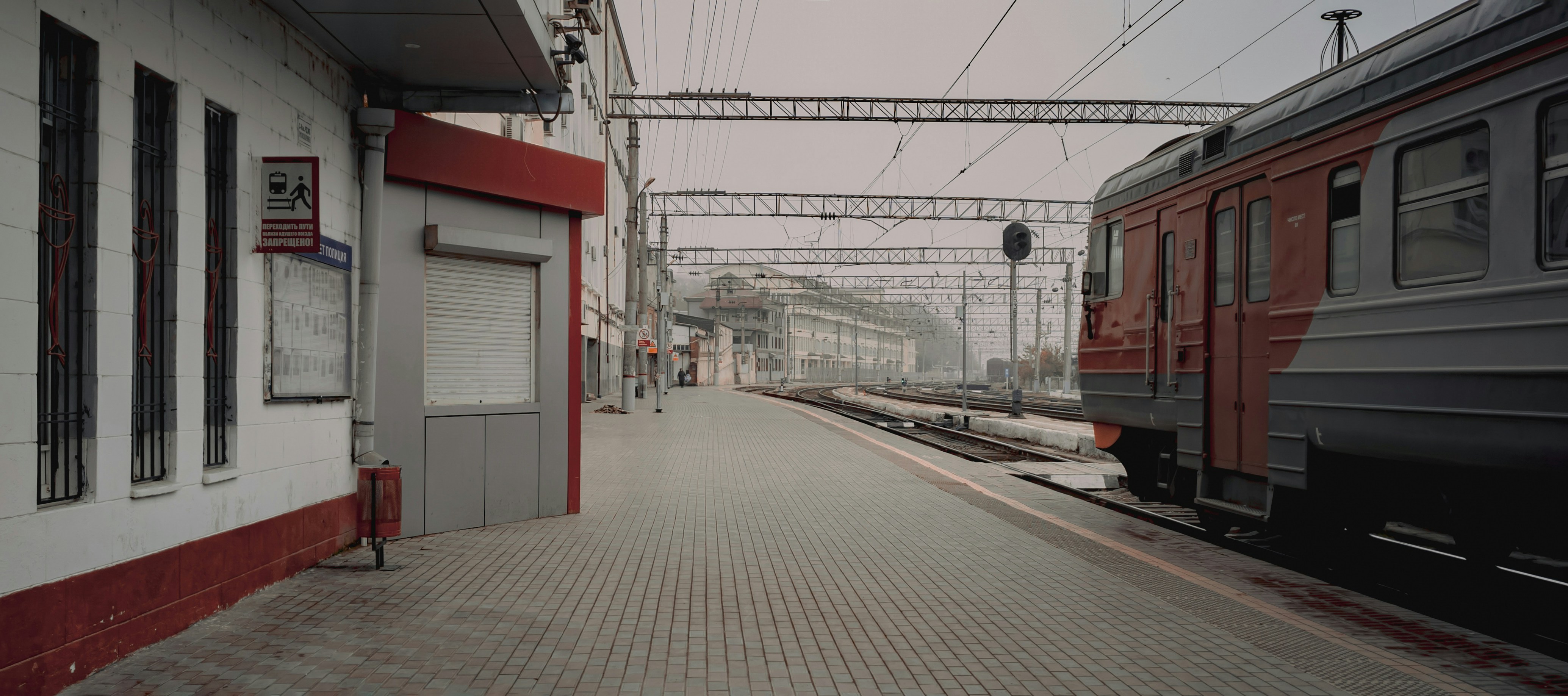 a train station with two trains parked next to each other