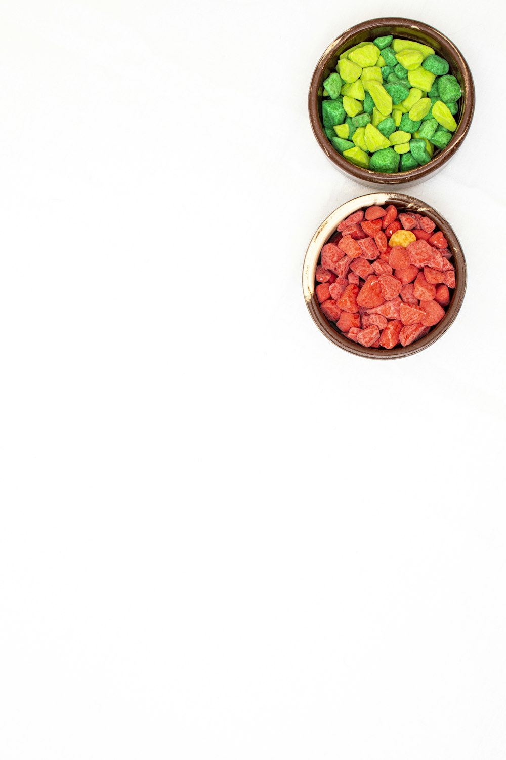 a couple of bowls filled with different colored candies