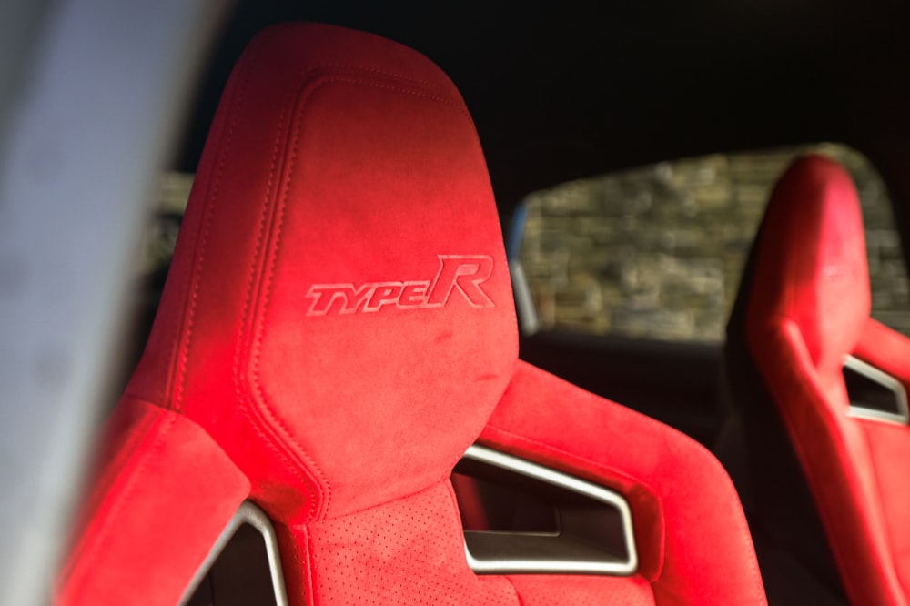 a close up of a red seat in a car