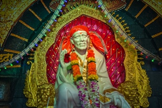 a statue of a man with a red headdress