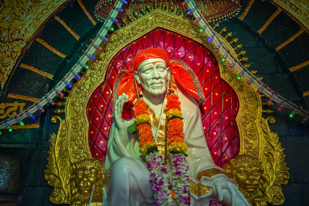 a statue of a man with a red headdress