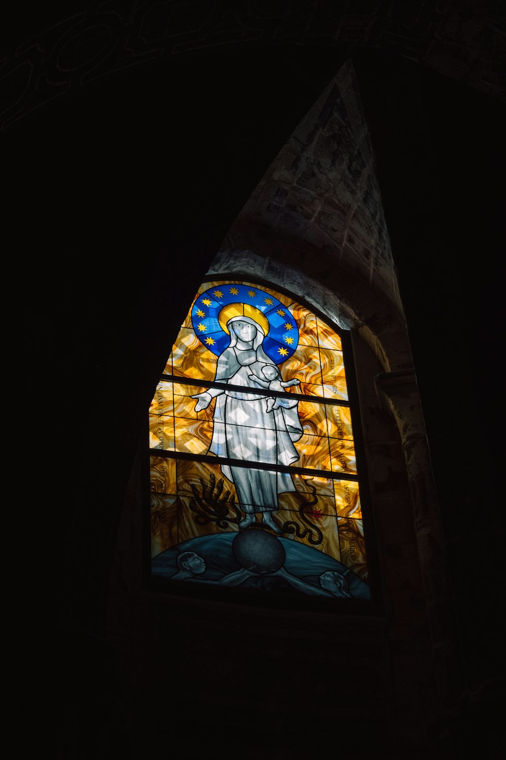 a stained glass window in a dark room