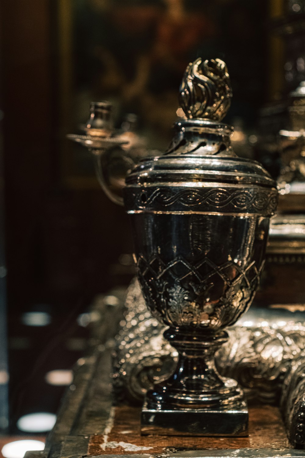 a silver vase sitting on top of a table