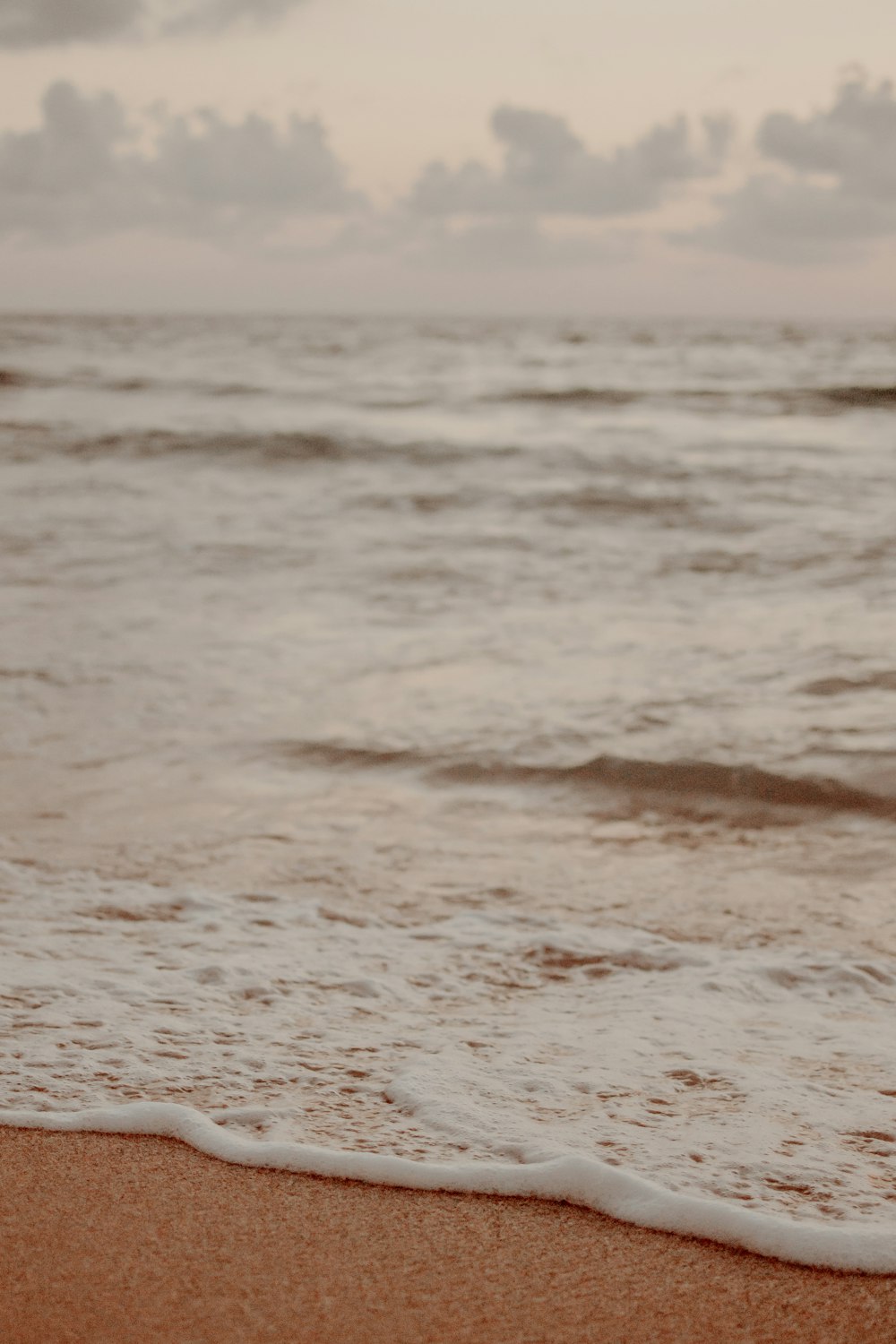 a close up of a surf board on a beach