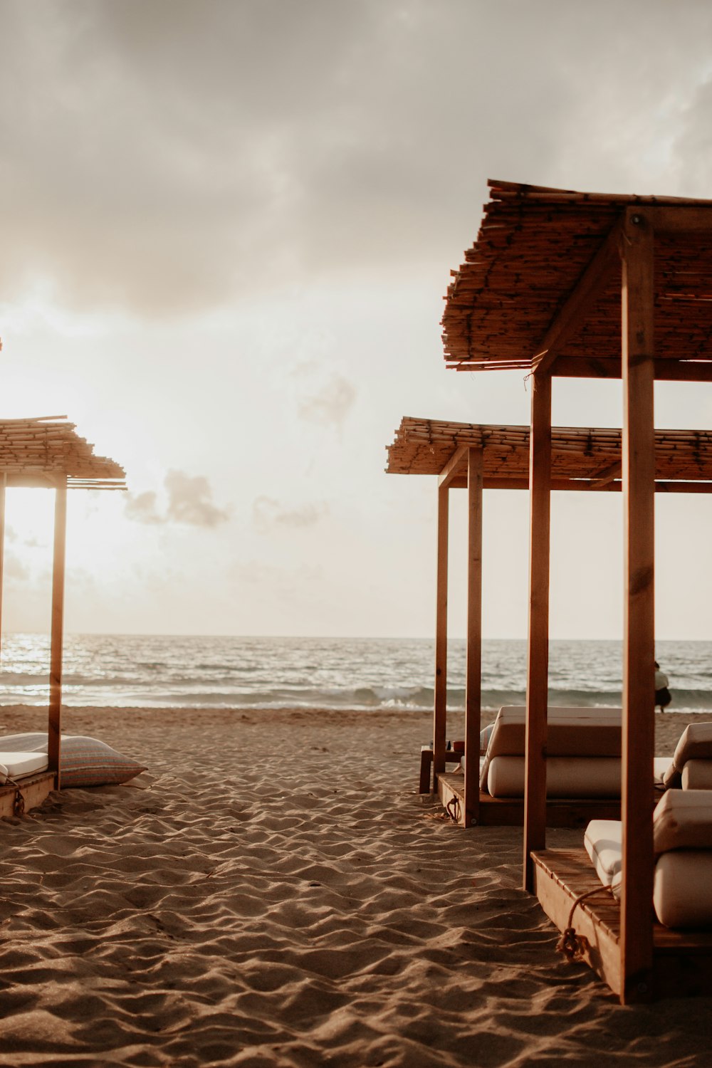 a row of beach chairs sitting on top of a sandy beach