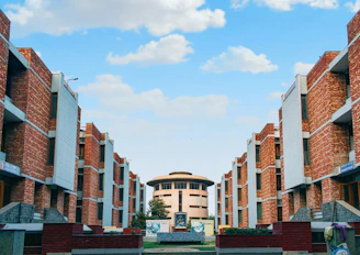 a group of buildings with a clock tower in the background