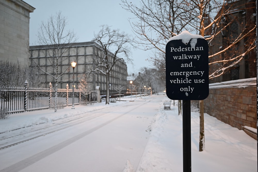 a sign that is on a pole in the snow