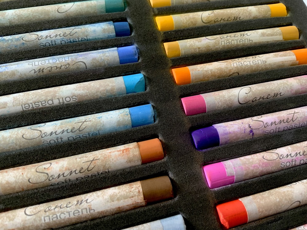 a bunch of different colored crayons in a box