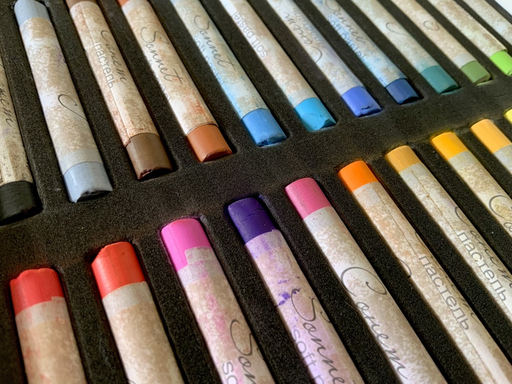a bunch of different colored crayons in a box