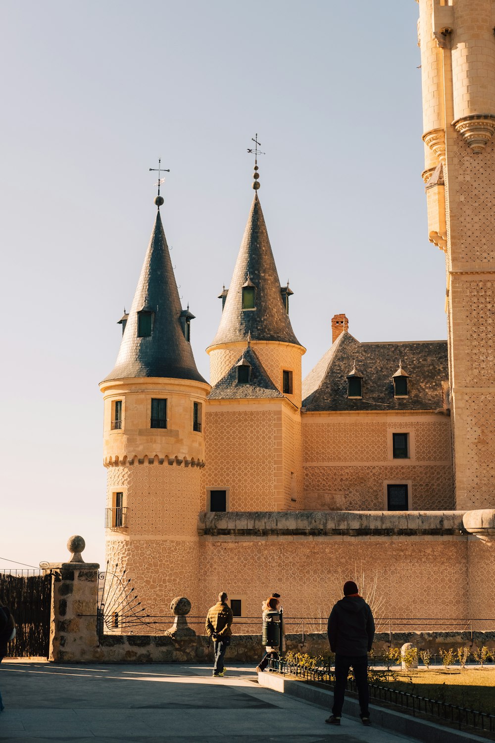 a couple of people that are standing in front of a castle