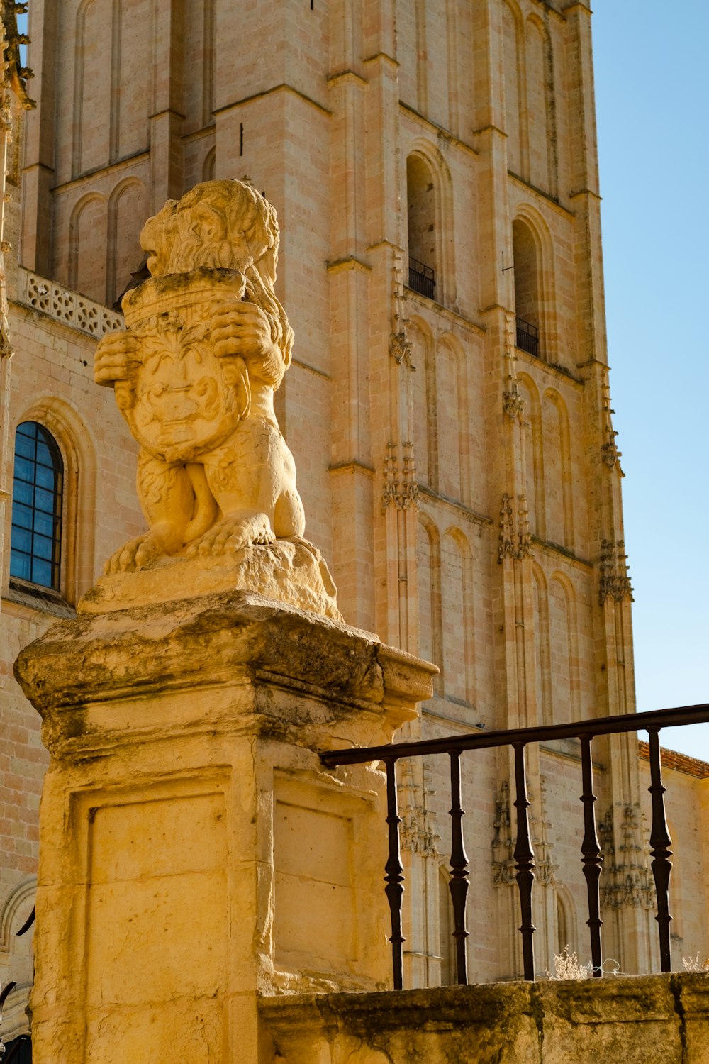 a stone lion statue in front of a tall building