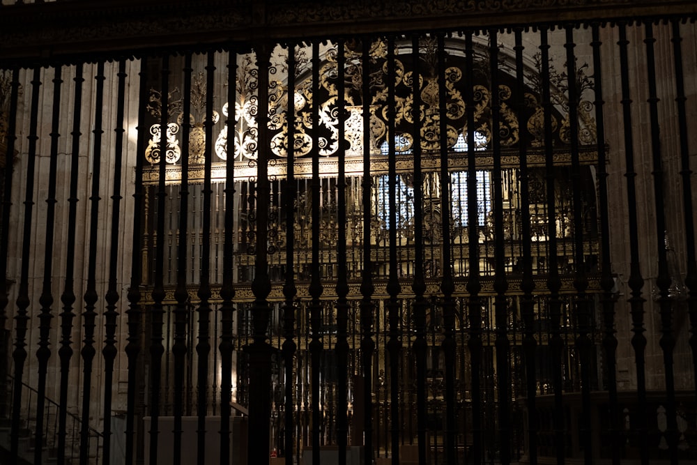 a large metal gate with a clock on top of it