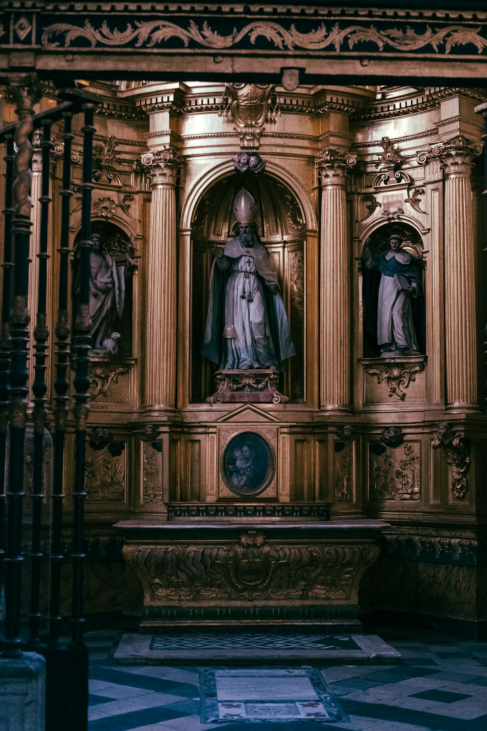 a golden alter with statues on it in a church