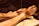 Close-up of a gentle whirlpool swirling around a diabetic foot in a spa basin.